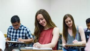 Photo of student writing notes in classroom